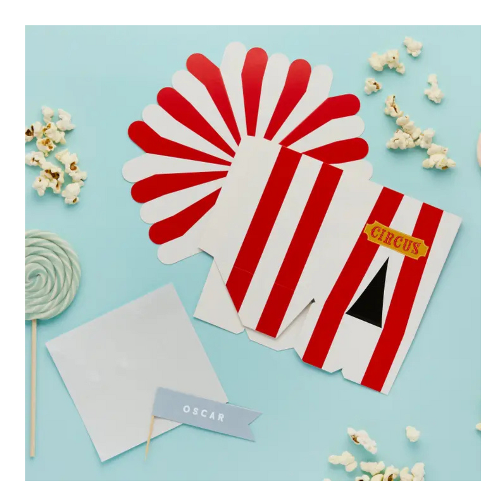 Red and white circus popcorn box flat packs with popcorn and lollipop for circus party from Parte Haus party supply store in Bethesda MD
