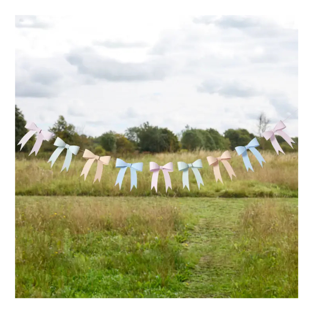 Pastel bow garland banner with pink blue and cream ribbons outdoor decoration from Parte Haus party supply store in Bethesda Maryland