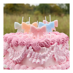 Pastel bow candles cake topper on pink frosted cake birthday theme from Parte Haus party supply store in Bethesda MD