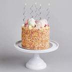 Silver wavy birthday candles on a pastel sprinkle cake for birthday from Parte Haus party supply store in Bethesda Maryland