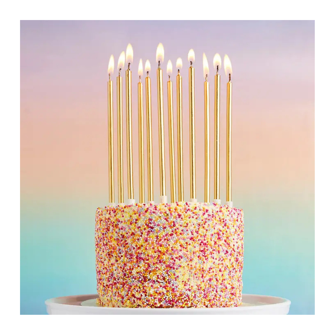Gold tall birthday candles on a sprinkle cake celebration from Parte Haus party supply store in Bethesda Maryland