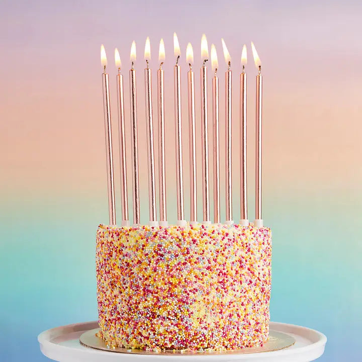 Rose gold birthday candles tall and slim on a sprinkle cake for birthdays from Parte Haus party supply store in Bethesda Maryland