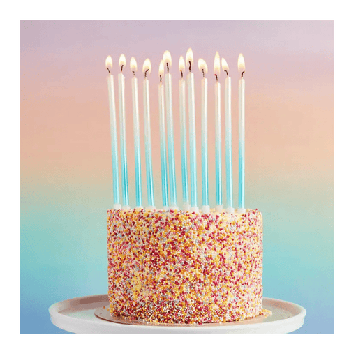 Blue tall birthday candles on rainbow sprinkle cake celebration from Parte Haus party supply store in Bethesda Maryland