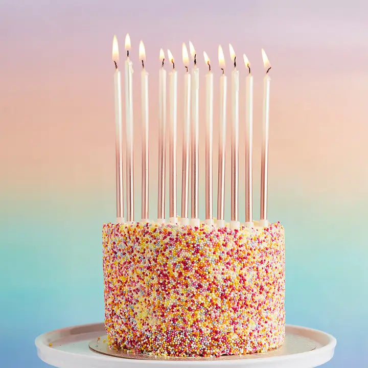Gold tall birthday candles on a sprinkle cake for birthday celebration from Parte Haus party supply store in Bethesda MD