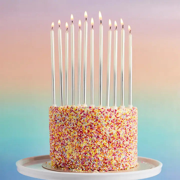 Silver birthday candles tall and slim on sprinkle cake for birthday celebration from Parte Haus party supply store in Bethesda MD