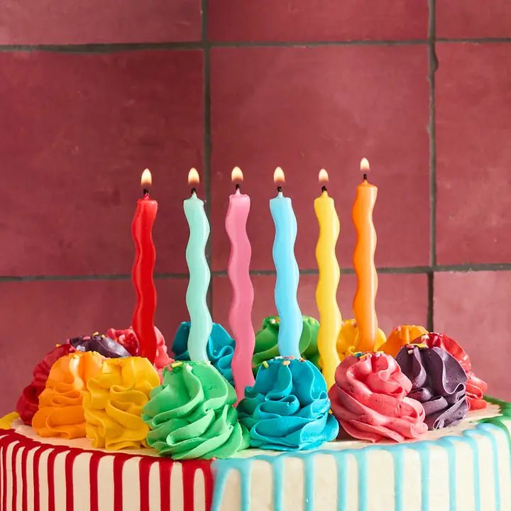 Rainbow wavy birthday candles on cake for birthday from Parte Haus party supply store in Bethesda Maryland