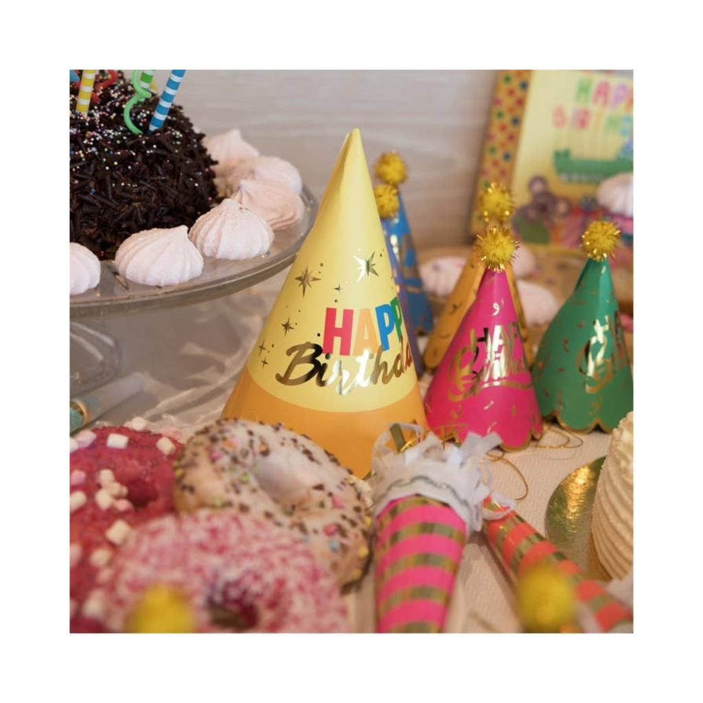 Yellow pink and green happy birthday hats with confetti decorations birthday theme from Parte Haus party supply store in Bethesda MD