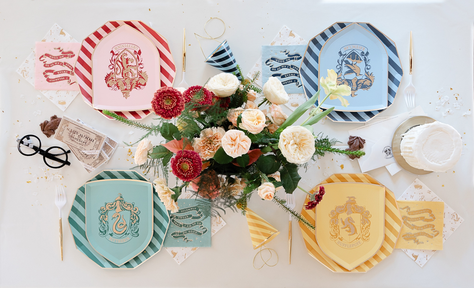 Multicolor Harry Potter house dinner plates with house crests birthday theme from Parte Haus party supply store in Bethesda MD