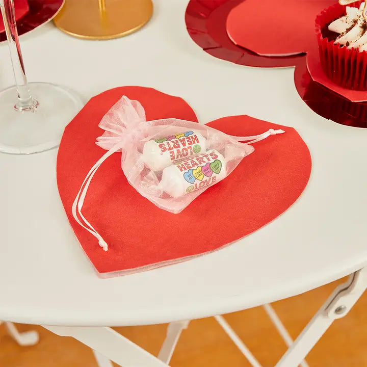 Red heart shaped paper napkin with candy favor bag for Valentine or love theme from Parte Haus party supply store in Bethesda Maryland