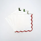 Red and green scalloped edge white cocktail napkins festive holiday decor from Parte Haus party supply store in Bethesda MD