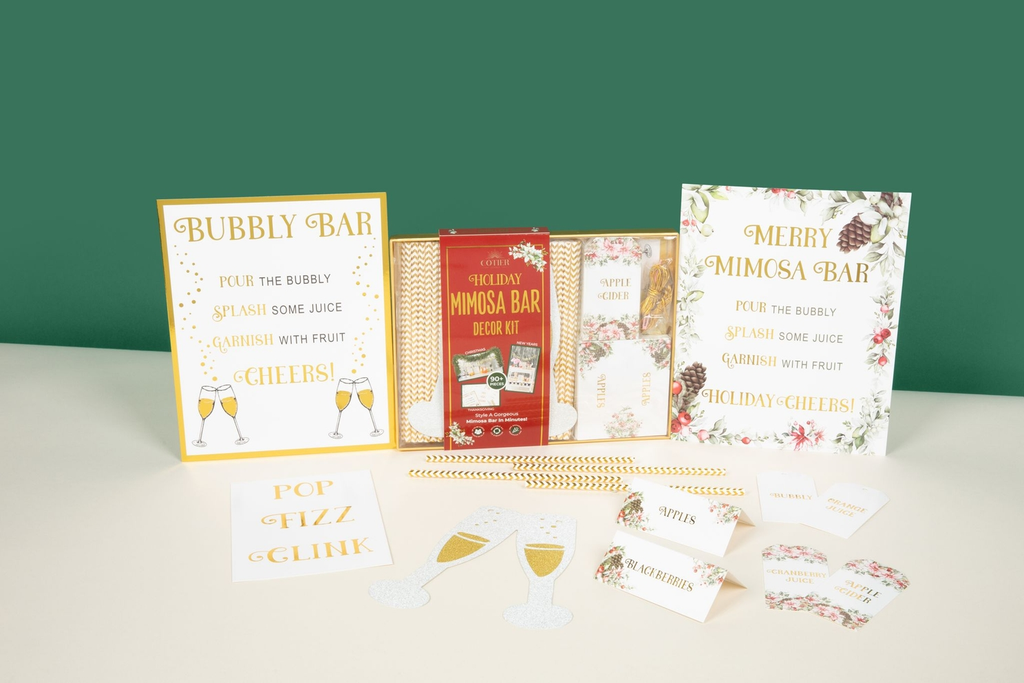 Gold and white holiday mimosa bar decoration kit with festive signs for Christmas from Parte Haus party supply store in Bethesda, Maryland