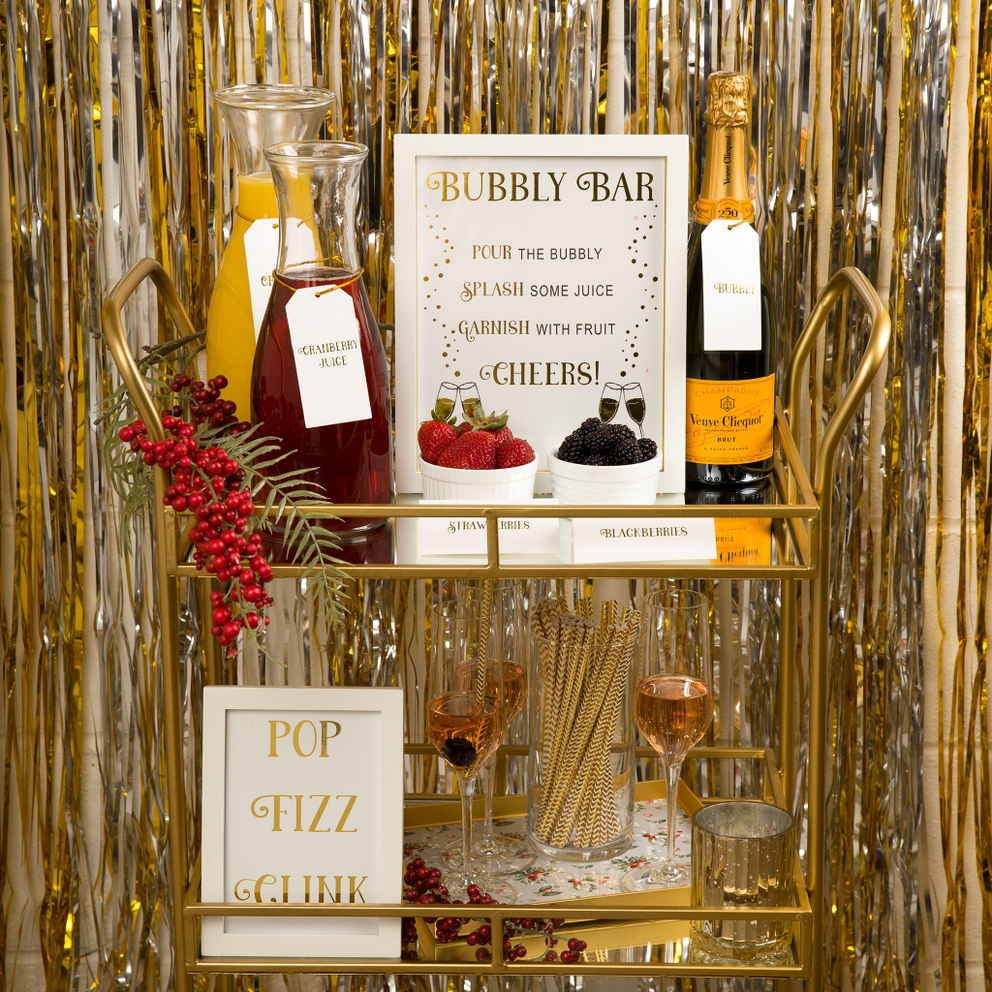 Gold holiday mimosa bar decoration kit with drinks and fruits for holiday celebration from Parte Haus party supply store in Bethesda, MD