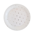 White paper plate with small round cutout holes from Parte Haus party supply store in Bethesda Maryland