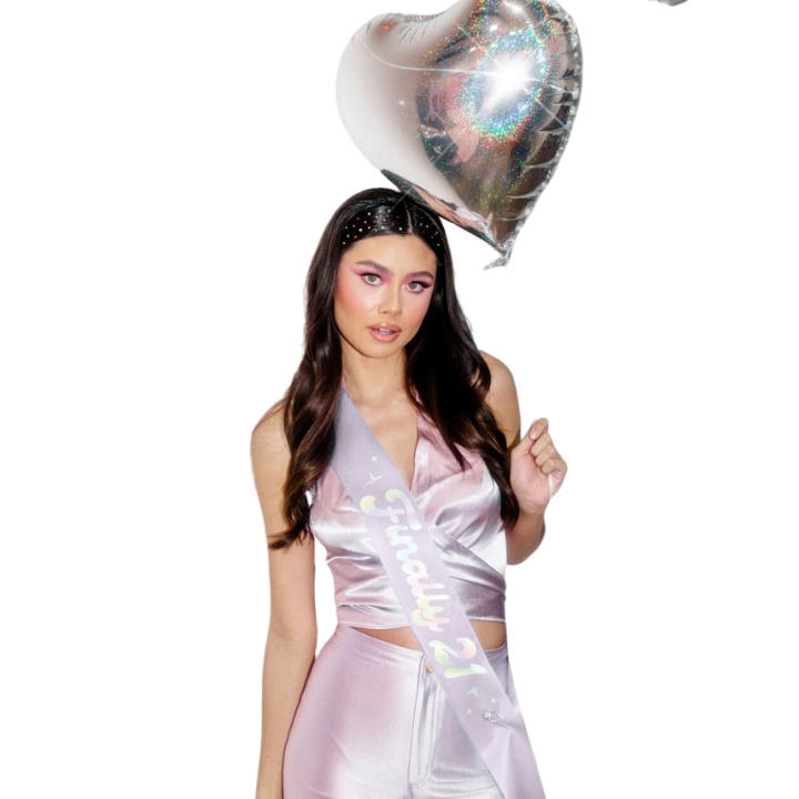 Pink birthday sash and satin outfit with heart balloon for 21st birthday from Parte Haus party supply store in Bethesda MD