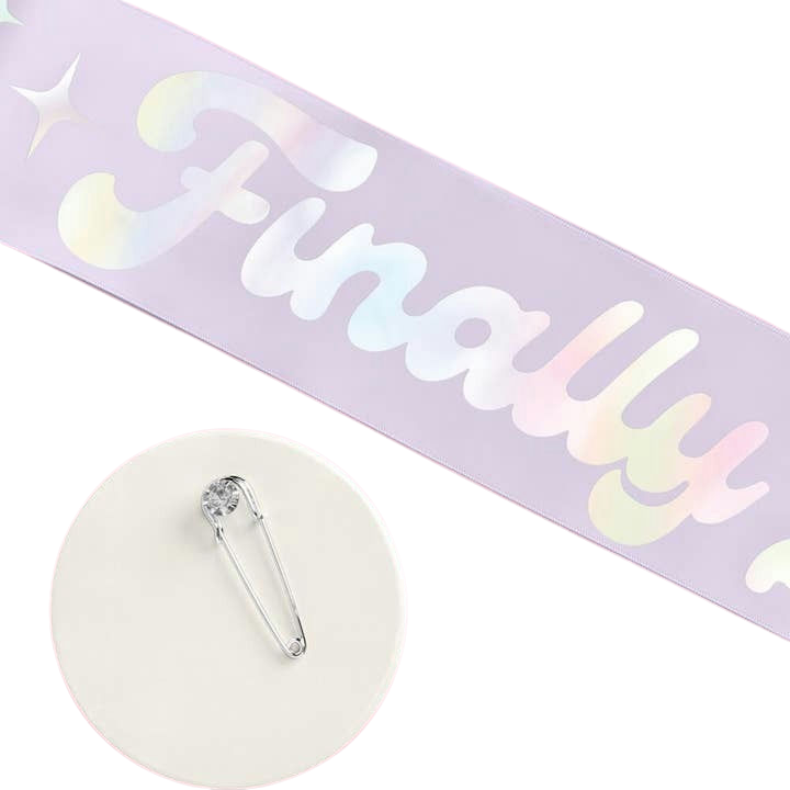 Iridescent pink graduation sash with finally text and safety pin from Parte Haus party supply store in Bethesda Maryland