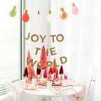 Red Joy large plates on festive striped holiday table Christmas party theme from Parte Haus party supply store in Bethesda MD
