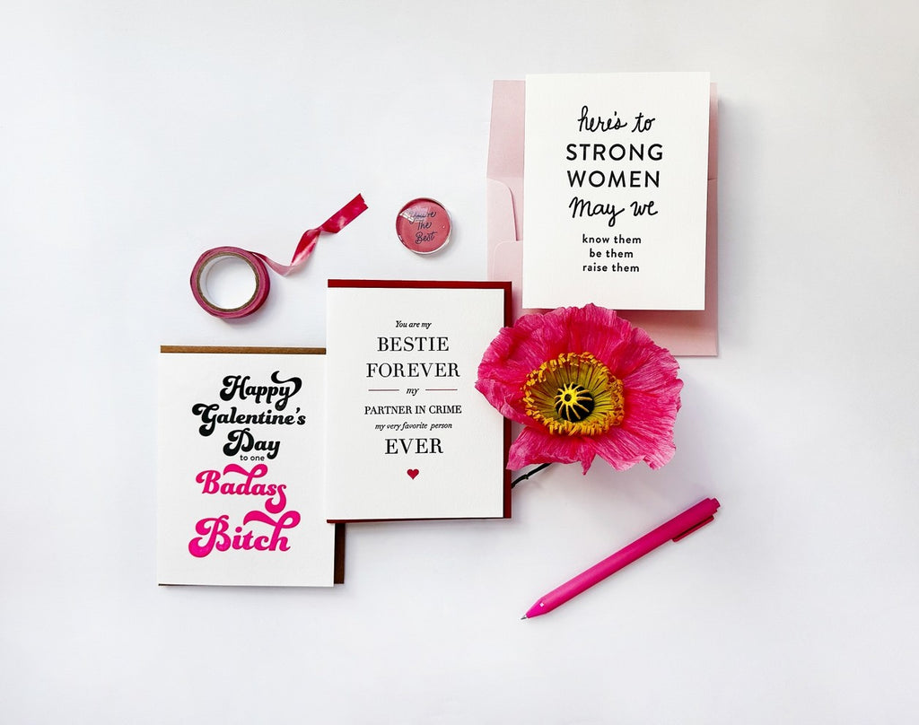 White and pink friendship cards with bold text flower pen and tape Galentine’s Day theme from Parte Haus party supply store in Bethesda MD.