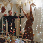 Gold Luxe Gold Confetti Cannon with people celebrating indoors at Christmas or New Years from Parte Haus party supply store in Bethesda MD