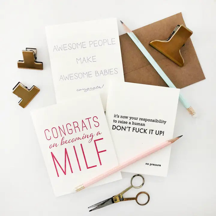 White and kraft letterpress congratulations cards with funny printed messages new baby and motherhood theme from Parte Haus party supply store in Bethesda MD