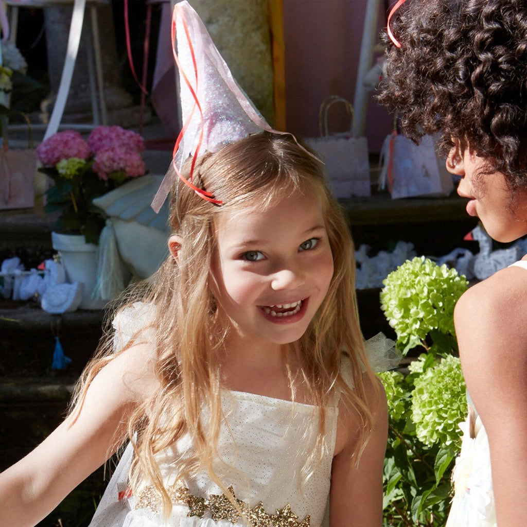 Iridescent princess party hats with ribbon details worn by smiling kids fairy tale birthday from Parte Haus party supply store in Bethesda MD
