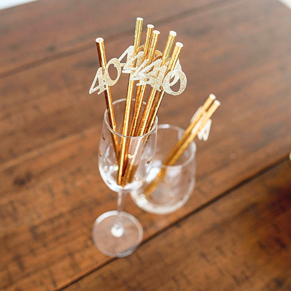 Metallic gold 40th birthday straws with glitter numbers on table decor from Parte Haus party supply store in Bethesda MD