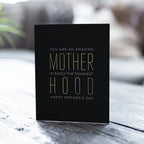 Black Motherhood greeting card with gold text for Mother’s Day from Parte Haus party supply store in Bethesda Maryland.