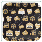 Black and gold movie theme dinner plate with popcorn and film icons for movie night from Parte Haus party supply store in Bethesda MD