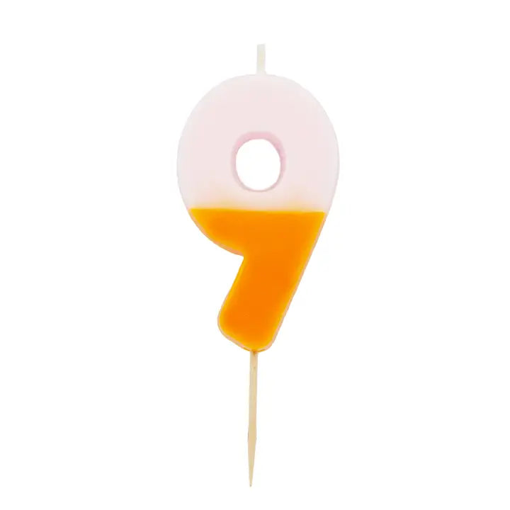 Multicolored number 9 candle pink and yellow birthday cake decoration from Parte Haus party supply store in Bethesda Maryland
