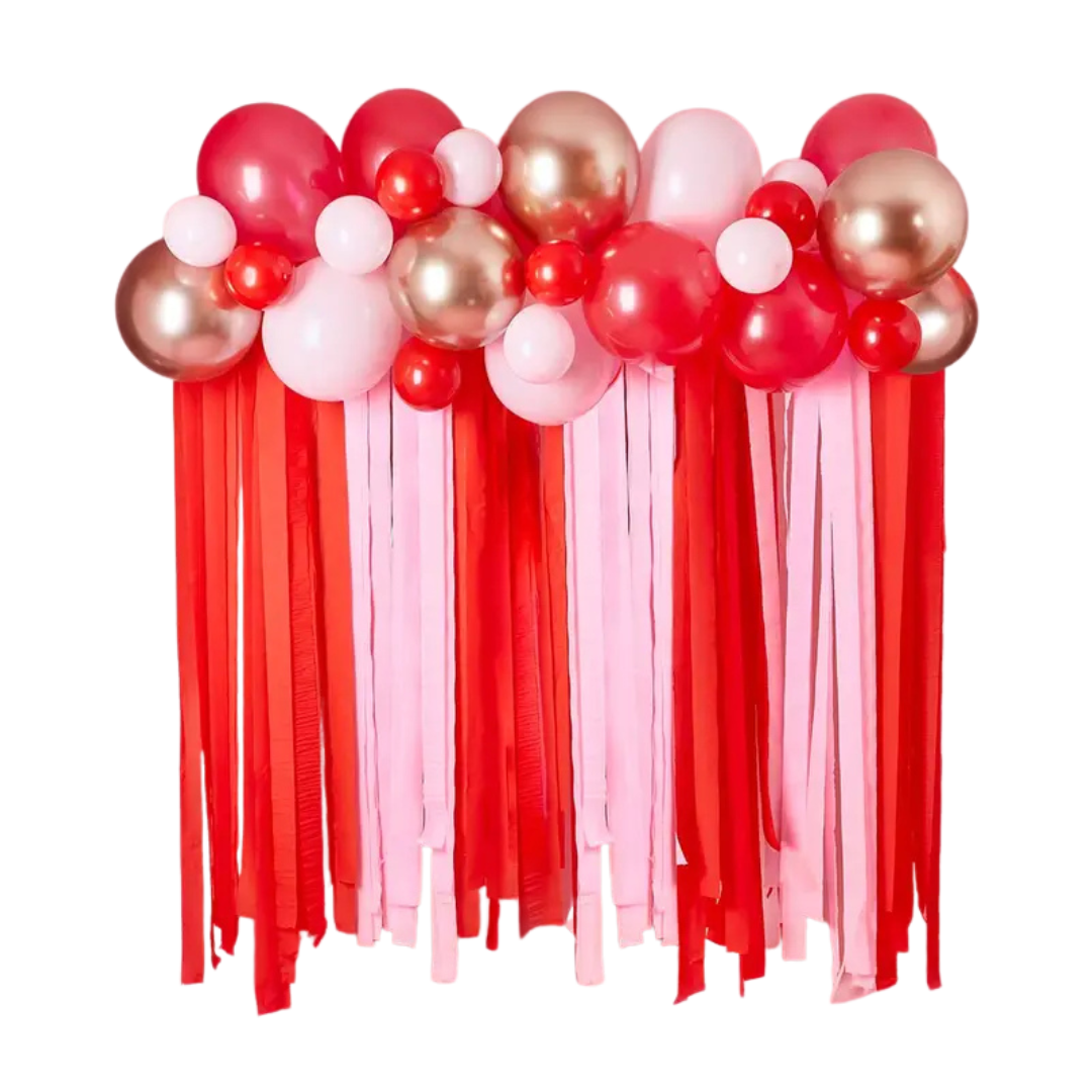 Red pink and gold balloon garland with streamers Valentine's Day display from Parte Haus party supply store in Bethesda MD