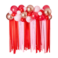 Red pink and gold balloon garland with streamers Valentine's Day display from Parte Haus party supply store in Bethesda MD