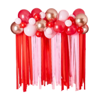 Red pink and gold balloon garland with streamers Valentine's Day display from Parte Haus party supply store in Bethesda MD