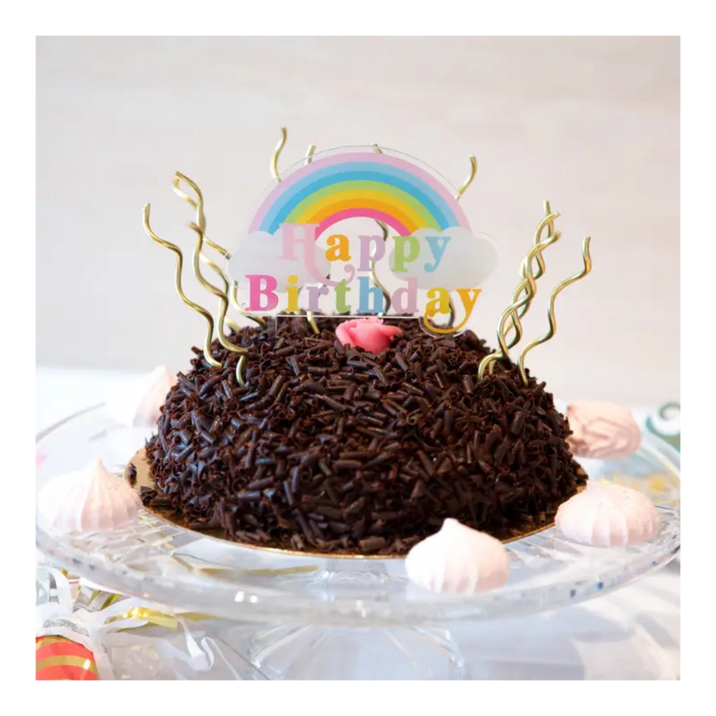 Chocolate birthday cake with rainbow topper for birthday celebration from Parte Haus party supply store in Bethesda Maryland