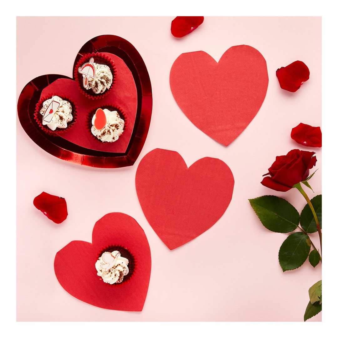 Red heart shaped plates with cupcakes and rose petals for Valentine’s Day from Parte Haus party supply store in Bethesda MD.