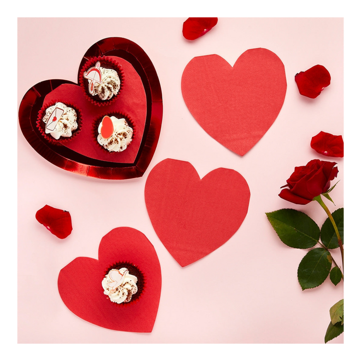 Red heart shaped plates with cupcakes and rose petals for Valentine’s Day from Parte Haus party supply store in Bethesda MD.