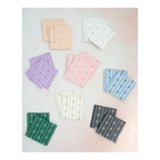 Multicolor cocktail napkins with gold bow designs for celebrations from Parte Haus party supply store in Bethesda MD.