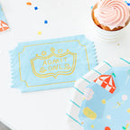 Light blue admit one napkin with gold fair ticket design carnival theme from Parte Haus party supply store in Bethesda MD.