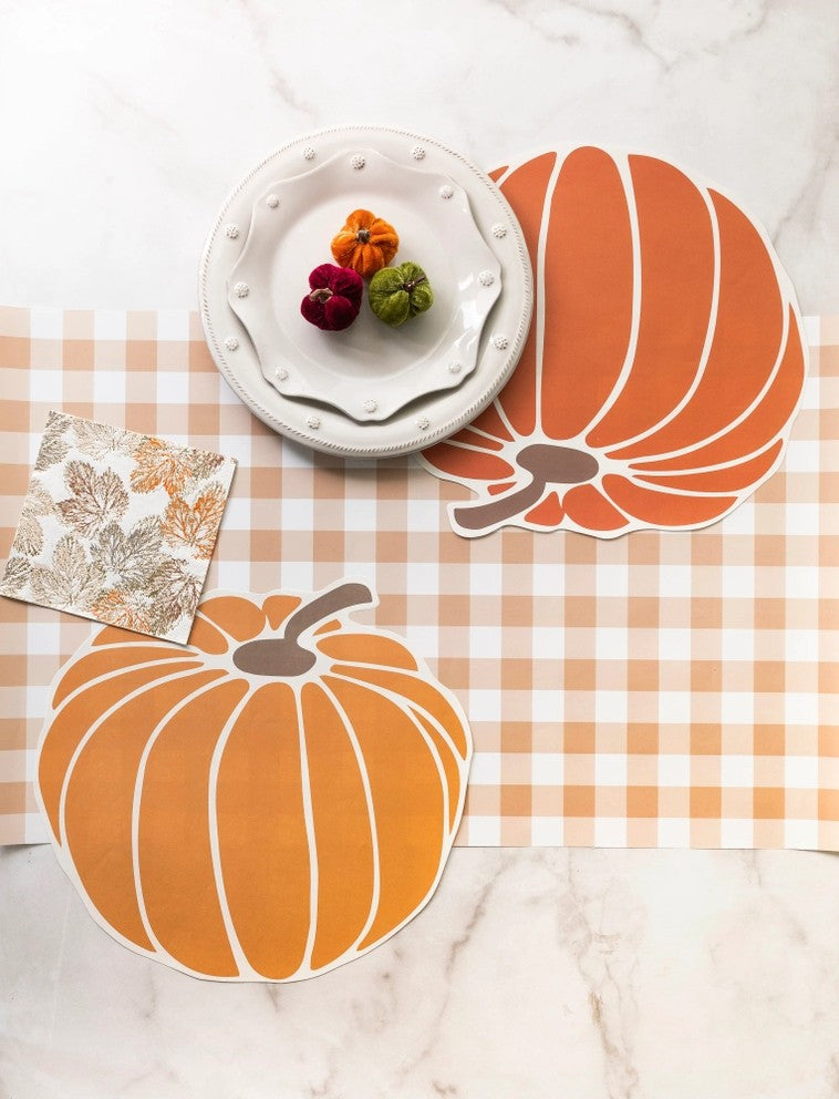 Orange gingham paper table runner with pumpkin cutouts for fall from Parte Haus party supply store in Bethesda MD