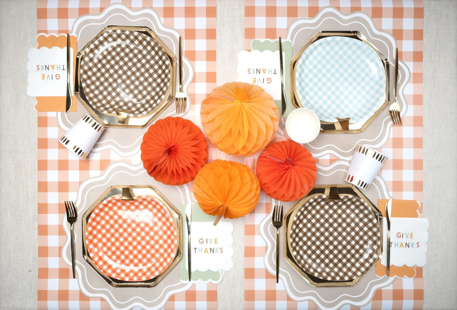 Orange gingham paper table runner with checkered plates and fall decor Thanksgiving theme from Parte Haus party supply store in Bethesda MD
