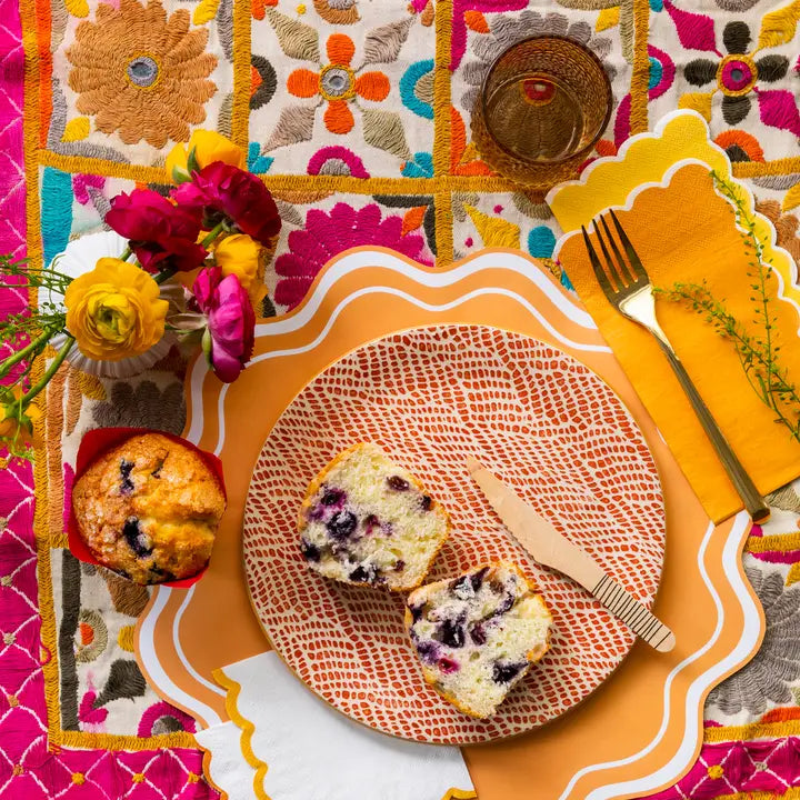 Orange wavy scallop paper placemats with modern design brunch table from Parte Haus party supply store in Bethesda MD
