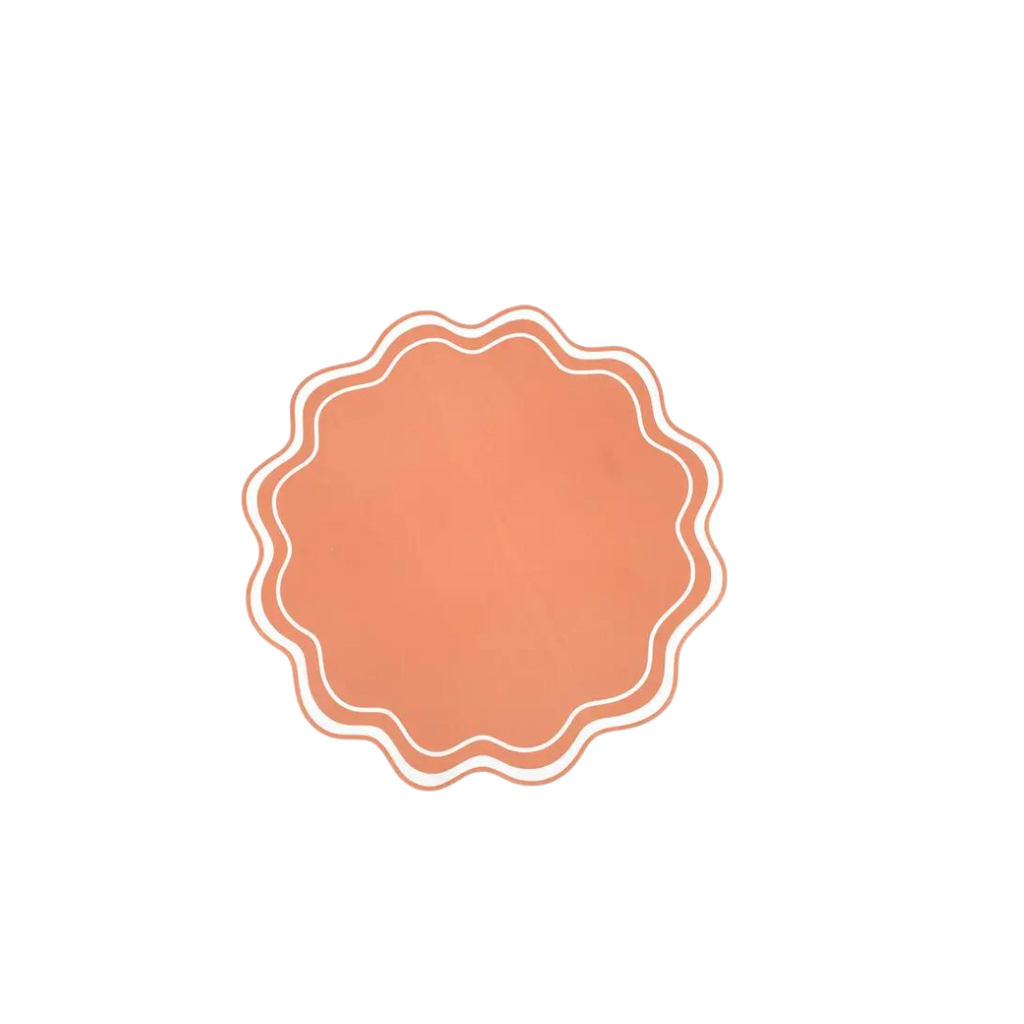 Orange wavy scallop paper placemat with white trim for celebrations from Parte Haus party supply store in Bethesda MD