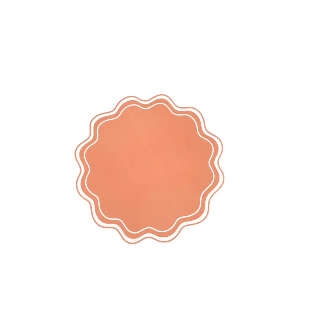 Orange wavy scallop paper placemat with white trim for celebrations from Parte Haus party supply store in Bethesda MD
