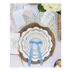 Blue and white floral paper plates with a blue ribbon bow on spring table setting from Parte Haus party supply store in Bethesda MD