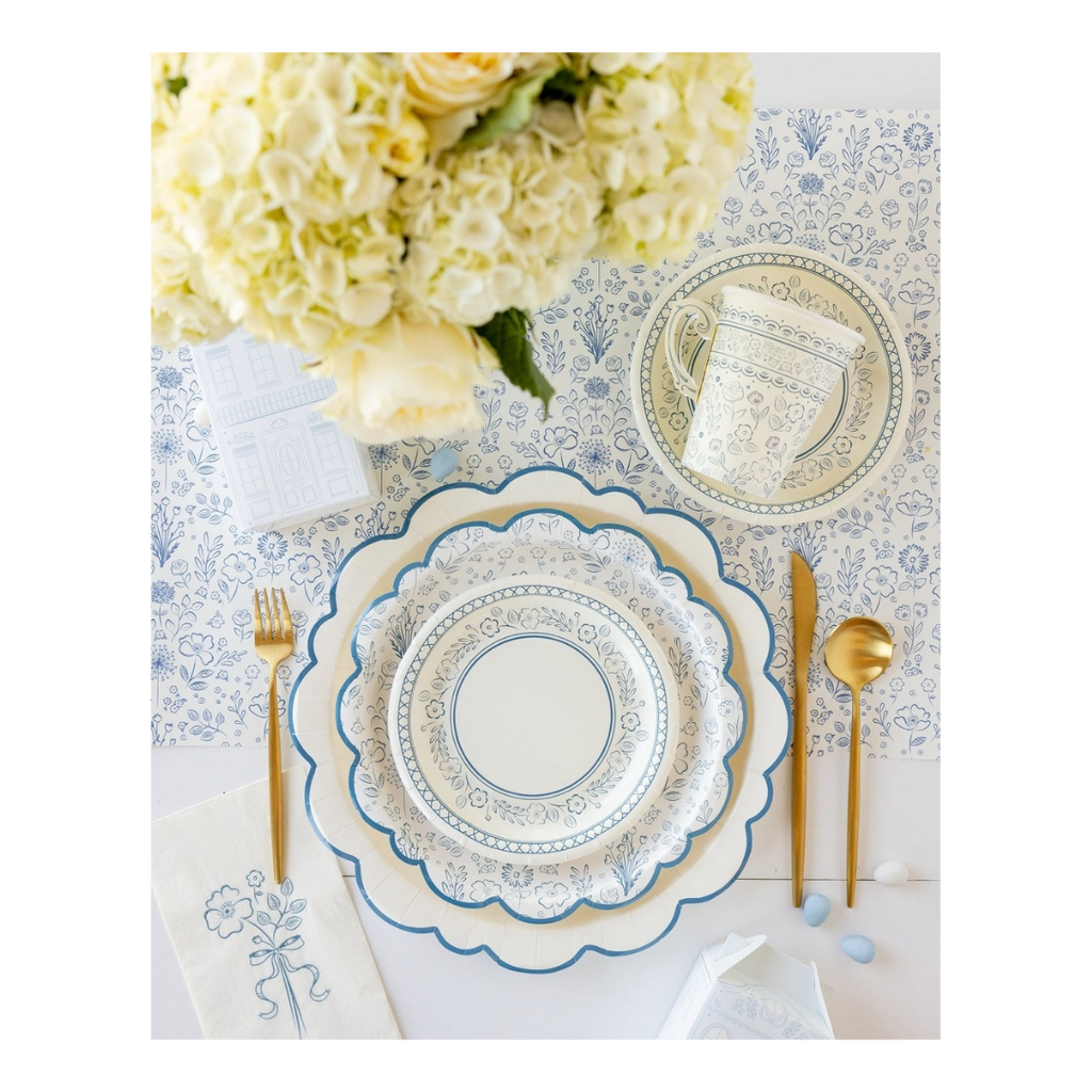 Blue and white floral paper plates with gold cutlery spring table setting from Parte Haus party supply store in Bethesda MD