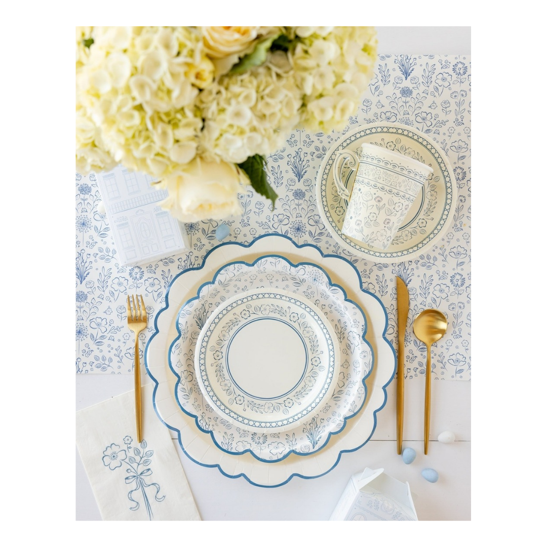 Blue and white floral paper plates with gold cutlery spring table setting from Parte Haus party supply store in Bethesda MD