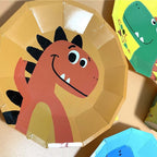 Yellow dinosaur plate with a smiling orange cartoon dinosaur for kids birthday from Parte Haus party supply store in Bethesda Maryland