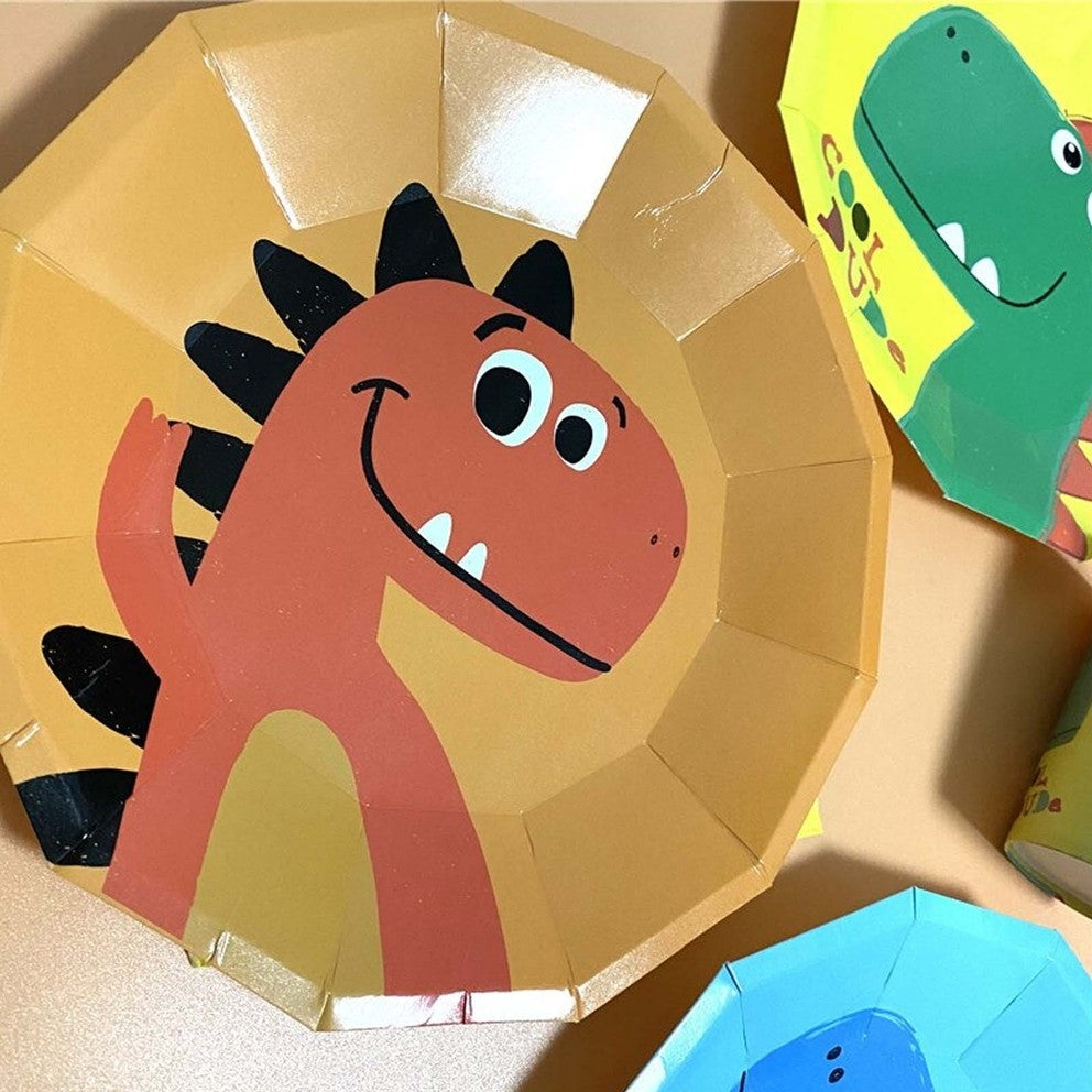 Yellow dinosaur plate with a smiling orange cartoon dinosaur for kids birthday from Parte Haus party supply store in Bethesda Maryland