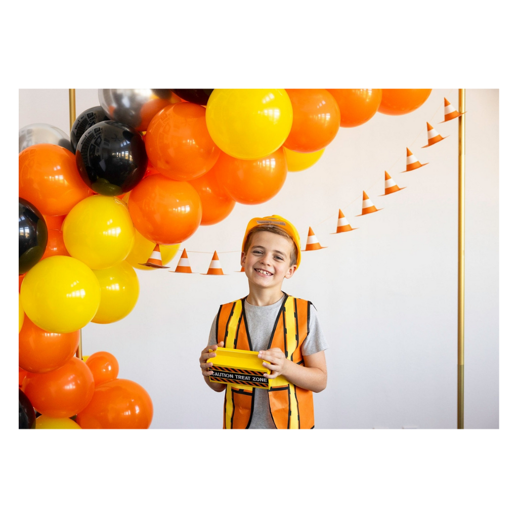 Orange and yellow construction birthday balloon arch and cone banner kids party theme from Parte Haus party supply store in Bethesda MD