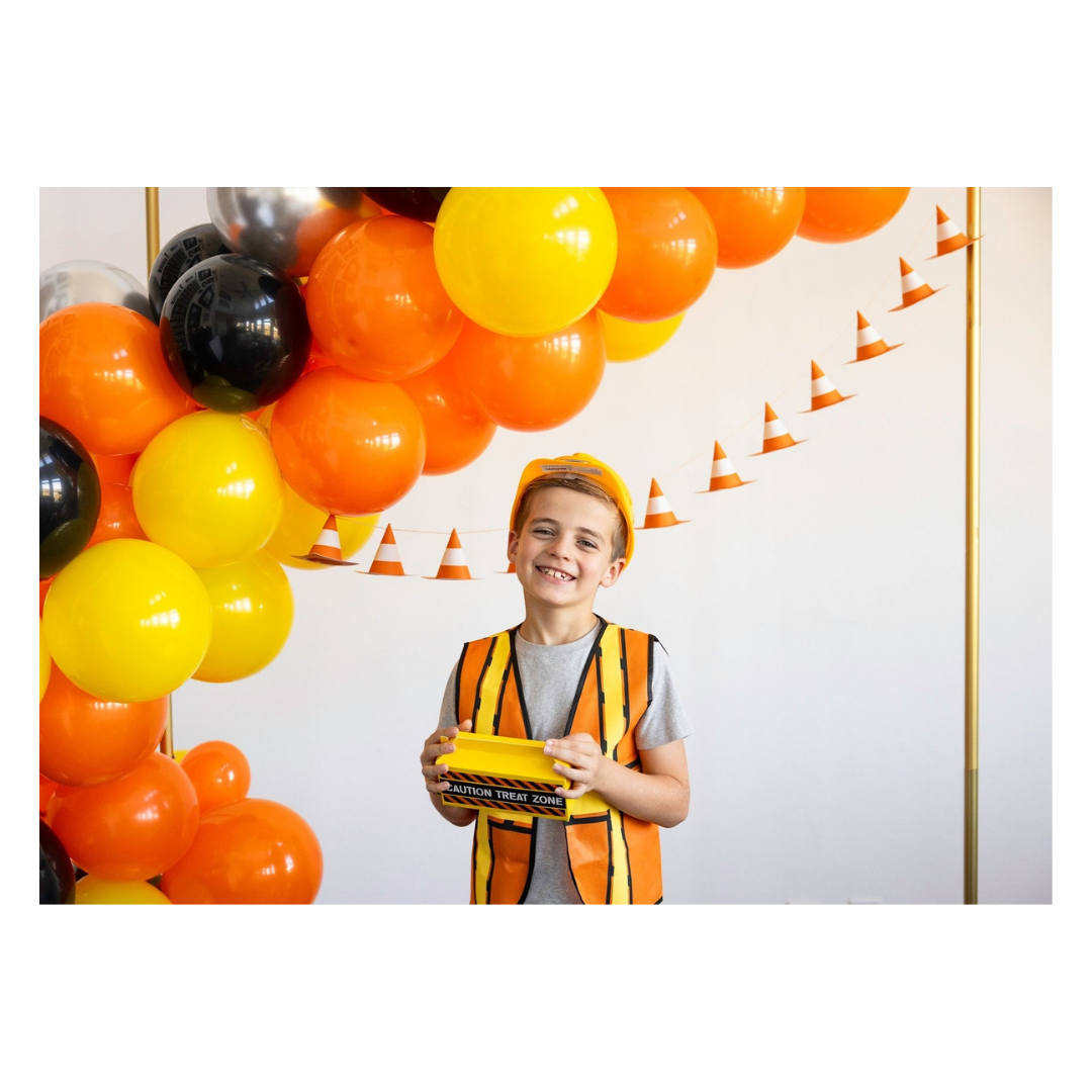 Orange and yellow construction birthday balloon arch and cone banner kids party theme from Parte Haus party supply store in Bethesda MD