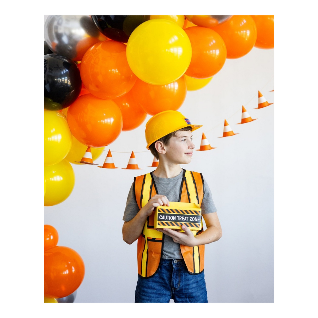 Yellow orange construction theme balloon garland with caution treat zone box for birthday from Parte Haus party supply store in Bethesda MD