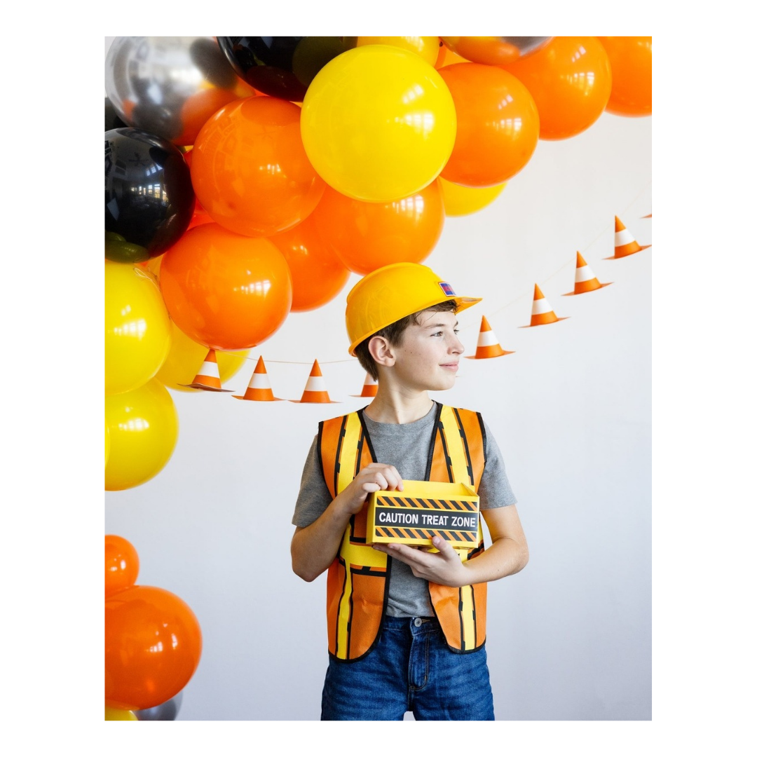 Yellow orange construction theme balloon garland with caution treat zone box for birthday from Parte Haus party supply store in Bethesda MD
